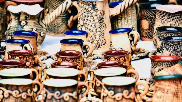 Mesa de feria con tejidos, cestería y cerámica artesanal de distintas regiones argentinas.