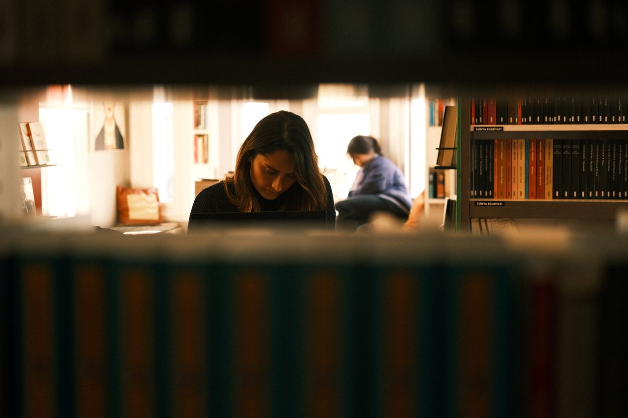 Sala de una biblioteca popular argentina con estanterías, mesas de lectura y computadoras comunitarias.